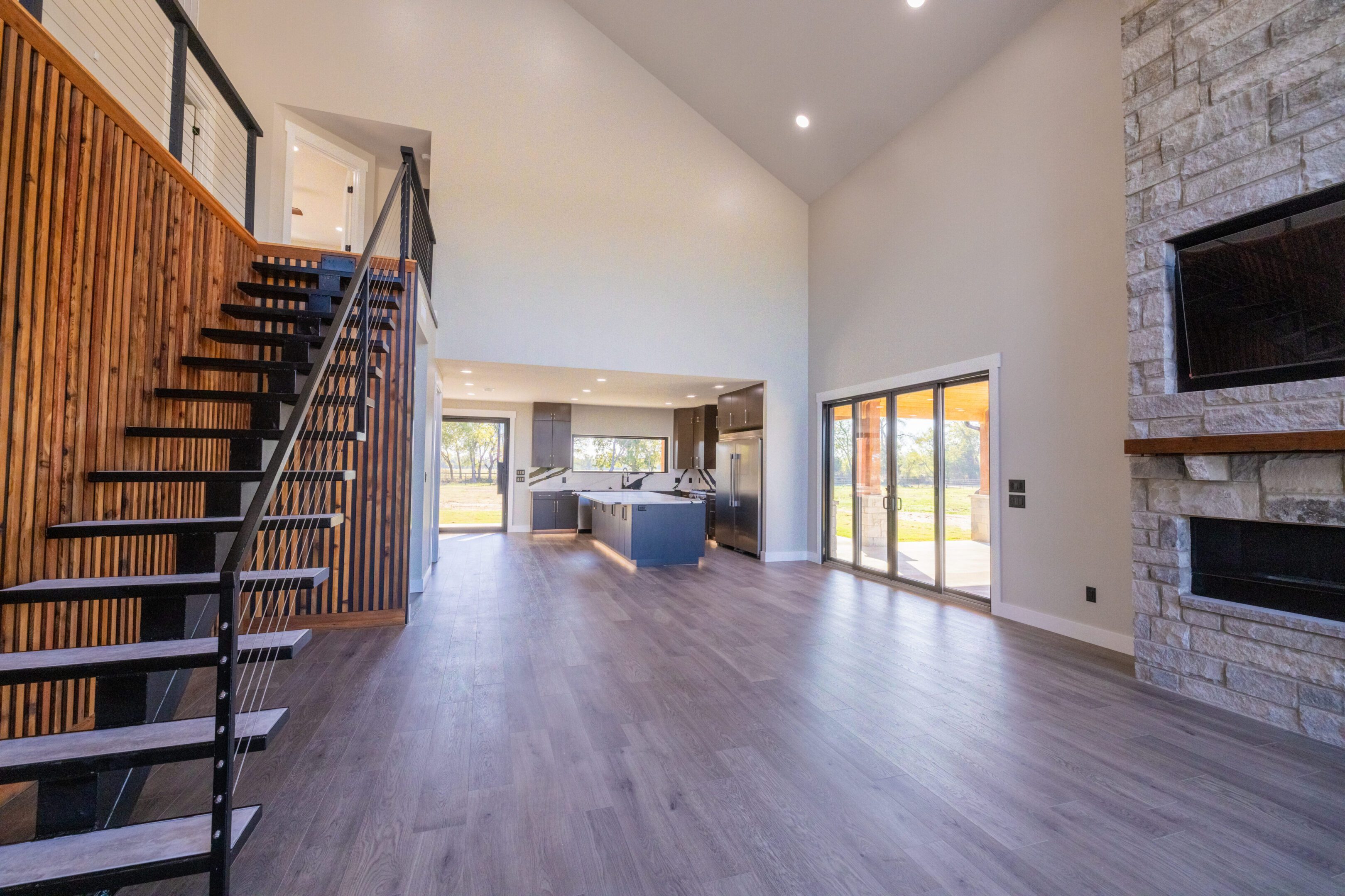 A large open floor plan with stairs leading to the living room.