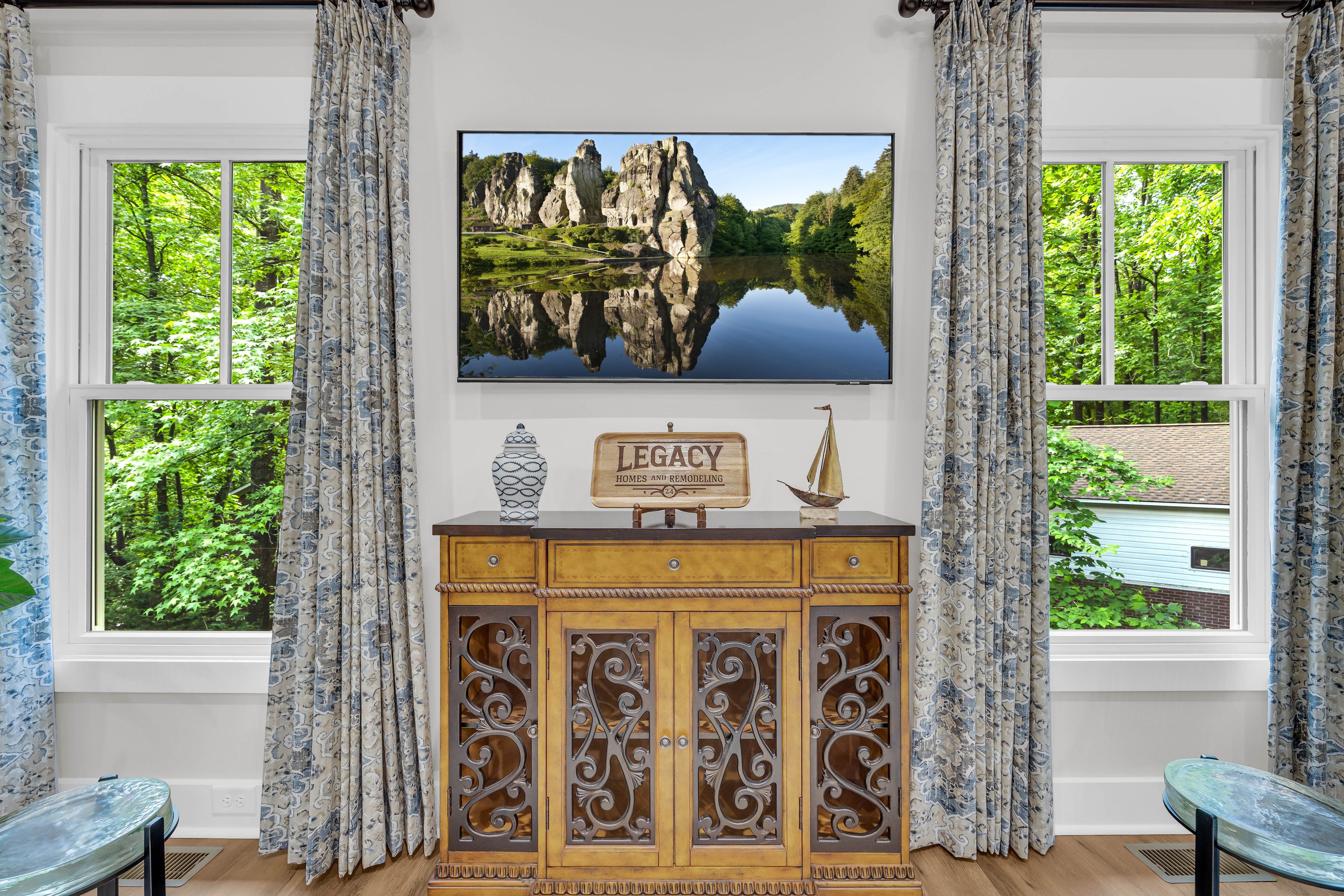 A painting of a lake and mountains on the wall.