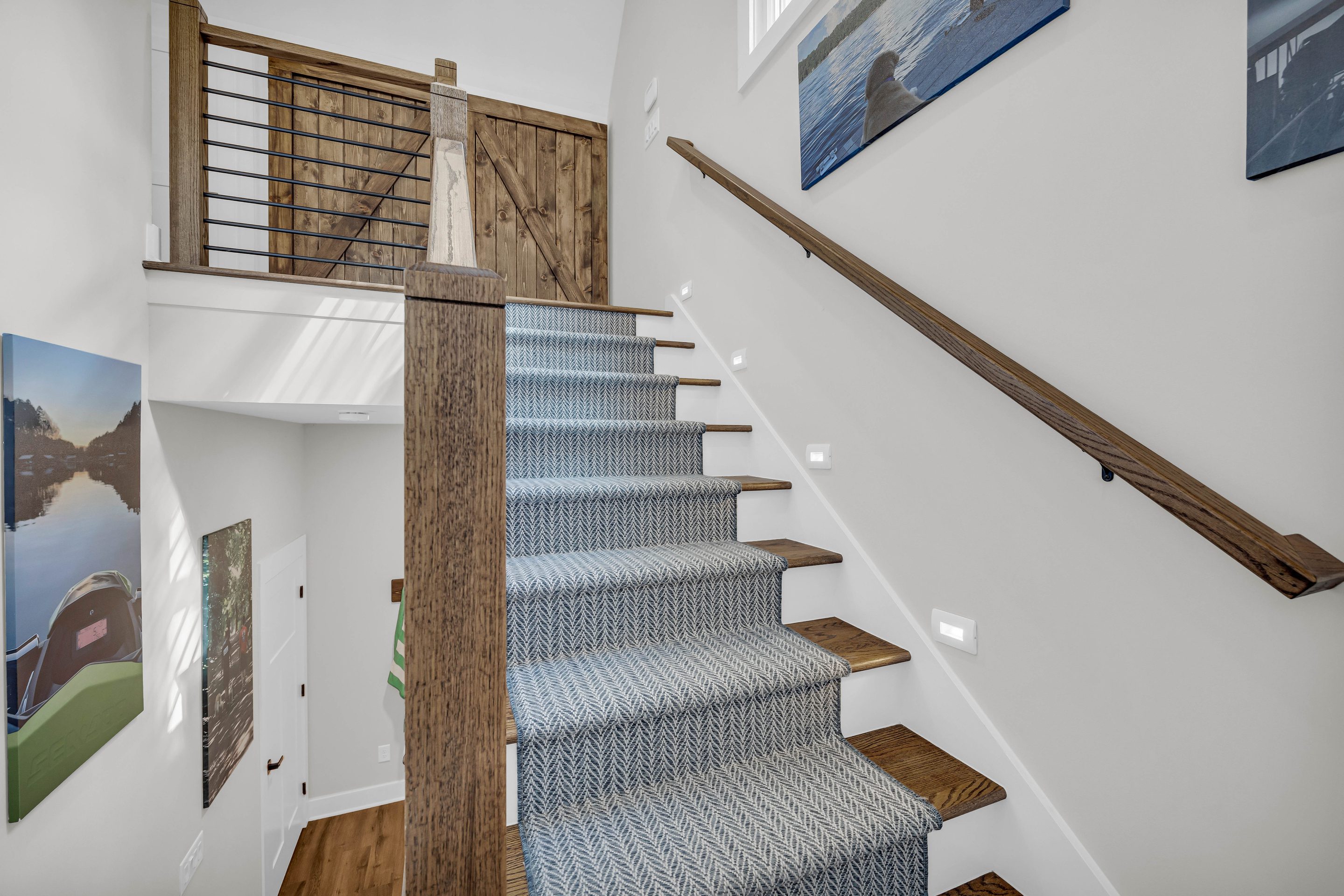 A staircase with blue and white striped carpet.