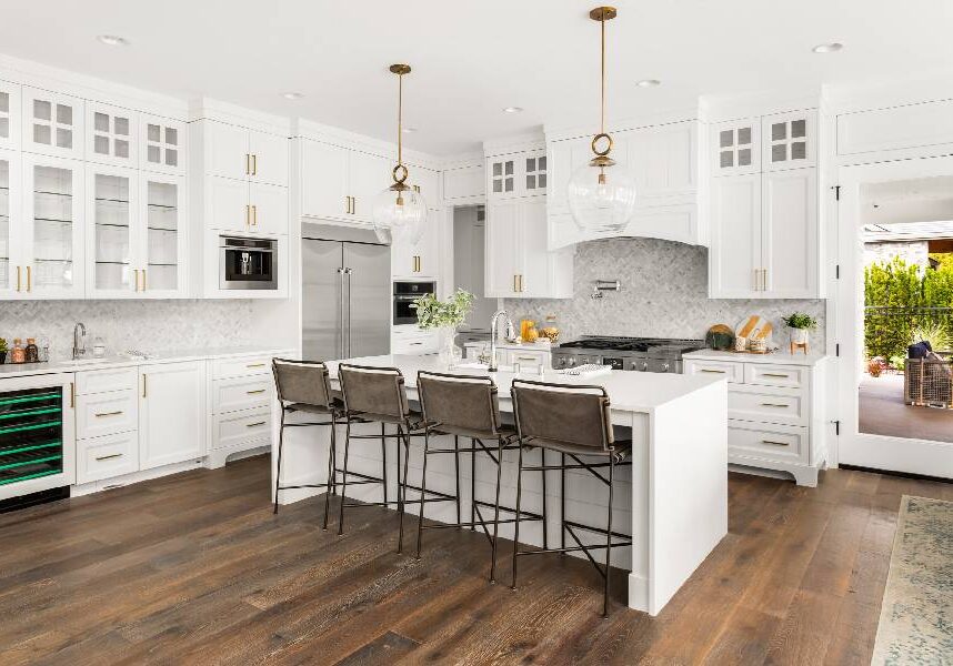 New Project (3) A kitchen with white cabinets and wooden floors