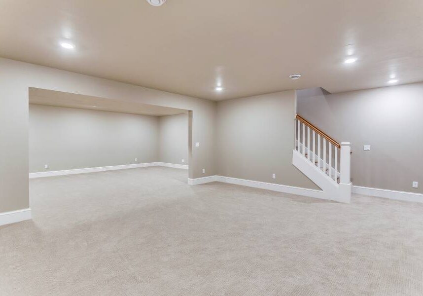 New Project (4) A large empty room with stairs and lights.