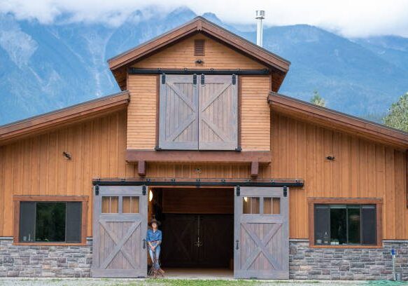 blog-1 A person standing in front of a barn.