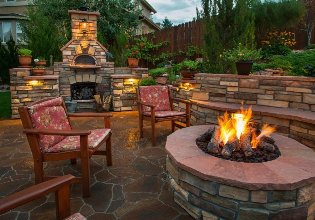 fm=f_532 A fire pit with chairs around it and lights on.